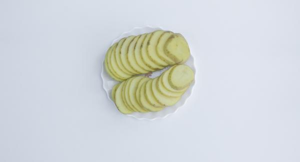 Cut onion into strips and potatoes into slices.