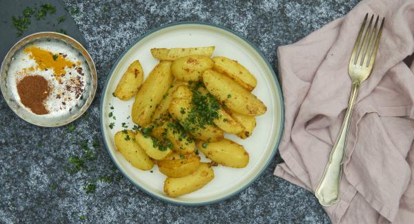 Pluck the coriander leaves, chop finely and sprinkle over the baked potatoes to serve.