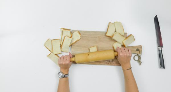 Halve bread slices. Roll flat with a rolling pin.