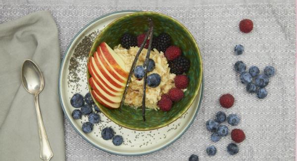 Leave the porridge open for a few minutes and then fold in the grated apple. Drizzle with maple syrup and serve warm.