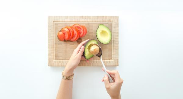 Stone the avocado, remove the fruit pulp with a spoon and spread it on the toasts.