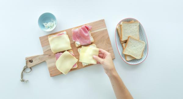 Smear four slices of toast with cream cheese or spread each with a slice of cheese. Spread them with cress, sprouts or salad leaves. Cut the tomato in thin slices and put one on each toast.