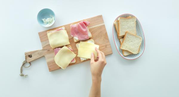 Smear four slices of toast with cream cheese or spread each with a slice of cheese. Spread them with cress, sprouts or salad leaves. Cut the tomato in thin slices and put one on each toast.