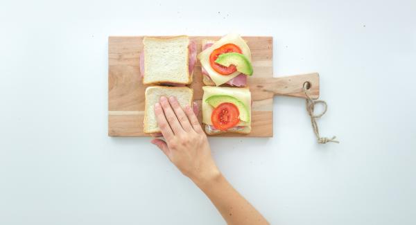 Place the remaining four slices of toast on top and press them together.