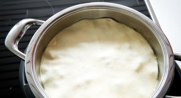 Pour egg and cream mixture over the vegetables and cover with the dough sheet.