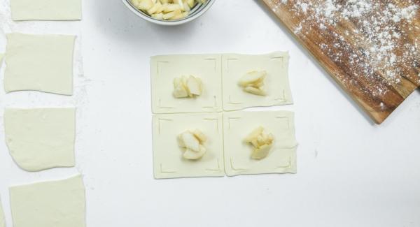 Place a few pear cubes in the middle and fold the edges of the dough over the pears like a flower and press down a little (see photo).