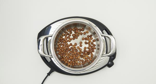 As soon as the Audiotherm beeps on reaching the roasting window, place nuts in the pot and place pot in inverted lid.