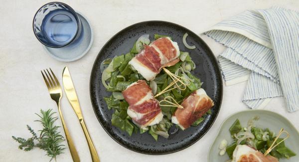 Fish saltimbocca served on a bed of green beans