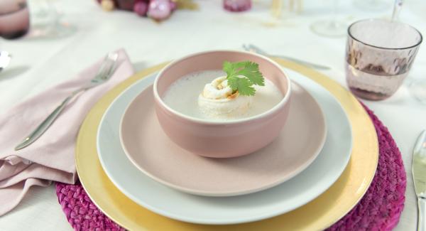 Foamy coconut soup with fish rolls