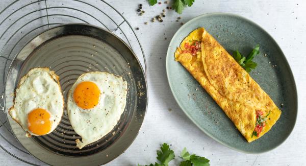 Stuffed omelette and fried eggs